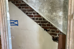 Interior of stairwell with staircase removed, viewing the first floor entrance